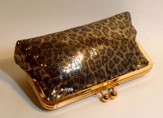 "Beautiful Leopard sequined clutch. It comes with a gold and gold frame. Lining can be changed to your custom color. Fabric: sequined fabric Lining: satin Two layers of interlining and batting Silver/nickel kisslock frame Top Width 8\" Bottom Width 9\" Height 5 1/2\" Reinforced stitching for durability *Note: A chain can be added for $4.00. Please see my chain listing. *The metal purse frame is made of iron with a nickel-free finish. It's hypoallergenic, itch and rash resistant for people with n Sequined Fabric, Metal Purse, Purse Frame, Metallic Purse, Bridal Clutch, Color Fabric, Dallas Tx, New Year's, Gold Frame