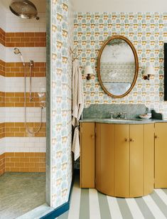 a bathroom with tiled walls and wooden cabinets