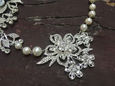 "Perfect for all bridal or party to wear!! Romantic shaped necklace featuring sparkle flower pendants and linked with pearl chains. Color: clear rhinestone crystals with pearls Size: necklace measures around 19.5\" long and large flower pendants around 6\" long x 3.25\" width Item ship out with tracking number to you (around 10 to 14 business days for delivery). We also provide fast shipping service, around 3-4 business days delivery but need to add extra charge. Please convo us if need." Wedding Pearl Drop Flower Pendant Necklaces, Pearl Flower Necklace For Wedding, Wedding Pearl Drop Flower Pendant Necklace, Silver Flower Pearl Necklace For Wedding, Flower Crystal Wedding Necklace, Wedding Crystal Necklace With Flower Design, Silver Pearl Wedding Necklace With Flower Pendant, Wedding Crystal Flower Necklace, Metal Rhinestone Necklace With Pearl Chain As Gift