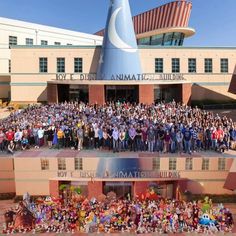 a large group of people standing in front of a building