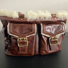 Vintage Coach Brown Distressed Leather. Fur Trimming And Gold Hardware. Sides Have Relaxed Thru Time. Braided Handles In Great Condition. Interior Is Spacious And In Good Condition. Lots Of Pockets. Collector’s Item Don’t Miss Out! Please See Photos For More Detail. Fur Bag, Bags Coach, Lots Of Pockets, Distressed Leather, Vintage Coach, Fur Trim, Coach Bags, Gold Hardware, Satchel