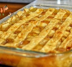 a close up of a pie in a glass dish on a table with other food items