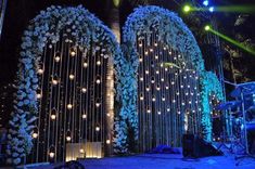 the stage is decorated with white flowers and lights