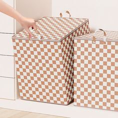 two brown and white checkered suitcases sitting next to each other