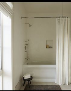 a white bath tub sitting next to a window