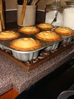 muffins are sitting on a baking tray in the kitchen