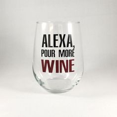 a wine glass with the words alexa pour more wine written on it in red and black