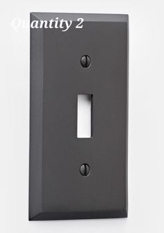 a black light switch cover with the words quantity 2 on it