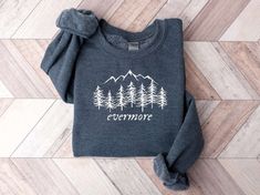 The Evermore Embroidered Sweatshirt 2D Crewneck Sweatshirt is the perfect gift for your family, designed to bring warmth, comfort, and style into their lives. This exquisite sweatshirt, with its intricately embroidered design, is a true work of art that will surely impress your loved ones. One of the standout features of this sweatshirt is the attention to detail in the embroidery. Crafted with precision and care, the intricate design adds a touch of elegance and sophistication to the overall lo Winter Loungewear Tops With Embroidered Graphics, Winter Embroidered Tops For Loungewear, Embroidered Sweatshirt For Everyday Fall Wear, Everyday Embroidered Fall Sweatshirt, Everyday Embroidered Sweatshirt For Fall, Embroidered Everyday Sweatshirt For Fall, Winter Sweatshirt With Embroidered Graphics For Loungewear, Winter Embroidered Graphic Sweatshirt For Loungewear, Winter Tops With Embroidered Logo For Everyday