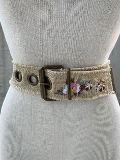 Vintage floral embroidery belt, 90s jute wide belt, bronze tone eyelets, boho hippie fashion accessories, maximalist boheme look, ibiza look Embrace the boho hippie spirit of the 90s with this Vintage Floral Embroidery Belt, a captivating jute wide belt that adds a touch of earthy elegance to any ensemble. The natural jute color exudes a rustic charm, complemented by exquisite floral machine embroidery and tasteful wooden beads. Designed to make a bold statement, this belt features large bronze tone eyelets that enhance its bohemian appeal, creating a striking contrast against the jute material. Its maximalist boheme look transports you to the laid-back vibes of Ibiza, making it the perfect fashion accessory for those seeking a unique and eclectic style. Crafted with attention to detail, t Boho Belts Bohemian Style, Bohemian Adjustable Belts For Summer, Adjustable Belts For Spring Festival, Adjustable Bohemian Summer Belts, Vintage Adjustable Belts For Summer, Embroidered Belt For Summer Beach, Vintage Adjustable Belts For Spring, Spring Festival Fabric Belt, Bohemian Embroidered Belt For Spring