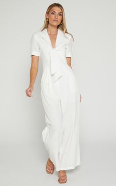 Get ready to turn heads in the Naples Wrap Front Jumpsuit In White! This wide leg jumpsuit is perfect for those casual summer days or dress it up with some heels for a night out. Made from 100% cotton, this jumpsuit is lightweight and breathable, keeping you cool and comfortable all day long. With its flattering wrap front detail and short sleeves, this jumpsuit will accentuate your figure in all the right places. So go ahead, embrace your playful side and add this flirty white jumpsuit to your White Jumpsuit Outfit, Jumpsuit Outfit Casual, Red Sequin Dress, Tiered Dresses, Basic Black Dress, Neon Outfits, Bachelorette Dress, Summer Capsule Wardrobe, Short Playsuit