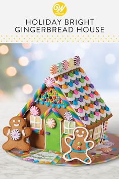 the gingerbread house is decorated with icing and sprinkles