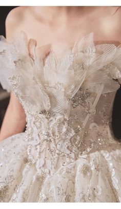 the back of a wedding dress with flowers on it