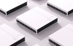 several white video game systems sitting on top of each other