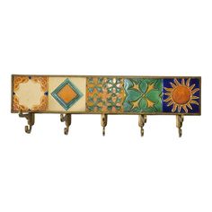 a multicolored coat rack with three hooks on each side and an orange sun in the center