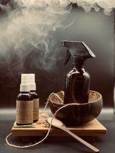 a bottle of air freshener sitting on top of a cutting board next to a wooden bowl