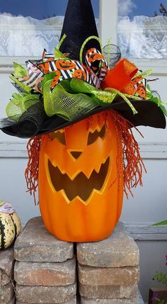 a pumpkin with a witches hat on top of it