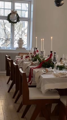 a dining room table set for christmas dinner