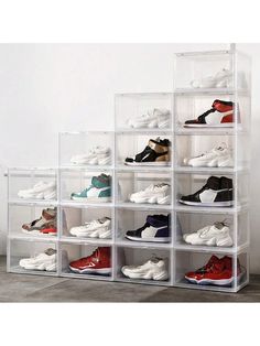 a stacking rack with many pairs of shoes in it and the bottom shelf is clear