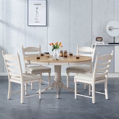 a dining table with four chairs around it