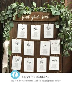 the seating chart for an outdoor wedding is displayed on a wooden board with greenery