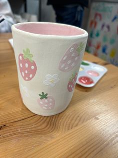 a cup sitting on top of a wooden table