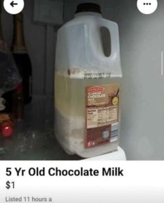 a gallon of chocolate milk sitting on top of a refrigerator