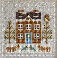 a cross stitch house with an owl on top