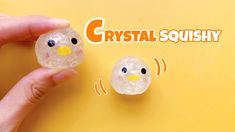 two crystal squishy birds sitting next to each other on top of a yellow surface