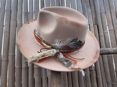 Decorated wide brimmed fedora hat will complement any outfit! With a western boho style, this hat can be for both casual and formal.  This hat has been burnt and hand stitched to give it a unique distressed appearance . Hand made hat-bands include a one of a kind design using an assortment of fabrics, premium leather and real feathers.  Please feel free to message me with any customization requests. These are quite literally completely customizable. One Size Fits MOST. 22 3/8 circumference inner Bohemian Felt Hat For Western-themed Fall Events, Bohemian Summer Felt Hat For Rodeo, Bohemian Fedora For Kentucky Derby, Artisan Fedora With Short Brim For Fall, Bohemian Felt Hat For Kentucky Derby And Western Events, Bohemian Felt Hat For Kentucky Derby, Bohemian Felt Hat For Western-themed Summer Events, Summer Bohemian Felt Hat For Western-themed Events, Bohemian Felt Hat For Summer Western-themed Events