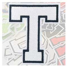 the letter t is surrounded by many stickers