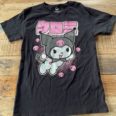 New! Sanrio/Hello Kitty Kuromi T Shirt. Black. Size: Small Kawaii Black T-shirt With Screen Print, Kawaii Black Top With Character Print, Kawaii Black Crew Neck T-shirt, Black Kawaii Top With Character Print, Kawaii Black T-shirt With Letter Print, Black Kawaii T-shirt With Character Print, Kawaii Black Top For Streetwear, Black Kawaii Top For Streetwear, Cute Black T-shirt With Screen Print