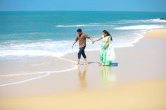 two people walking on the beach holding hands