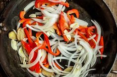 onions and peppers are being cooked in a skillet