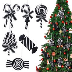 a christmas tree decorated with black and white candy canes hanging from it's sides