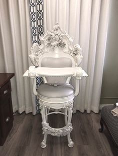 a white chair sitting in front of a mirror