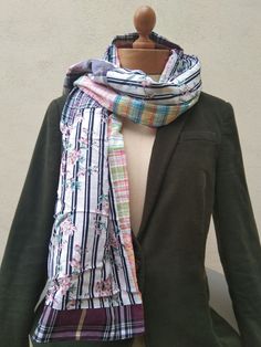 a mannequin wearing a jacket and scarf