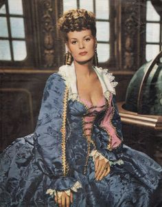 an old photo of a woman in blue dress