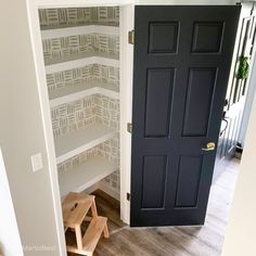 an open door leading into a room with wooden steps and wallpaper on the walls