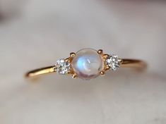 Rainbow moonstone ring, Moonstone engagement ring, stacking ring, Gold moonstone ring, Natural moonstone diamond ring, dainty promise ring Same design can be made also with other custom gemstones per request. Product details:- Solid gold (9k, 14k)- approx 5mm  moonstone round (AAA quality)- 2.5mm Diamonds ( G, VS-SI )- Band size is 1.4mm- Made to order - 8 to 10 business days.Ring size - US 3 to US 9 (for smaller or larger ring size, please contact)Please select your size at the drop down menu. Moonstone Gold Ring, Minimalist Moonstone Ring With Rose Cut Diamonds For Wedding, Dainty Diamond Moonstone Ring For Anniversary, Dainty Moonstone Ring With Rose Cut Diamonds For Wedding, Delicate Moonstone Ring With Rose Cut Diamonds, Dainty Moonstone Ring With Diamond, Delicate Round Moonstone Ring, Dainty Moonstone Diamond Ring, Elegant Stackable Moonstone Ring With Diamond