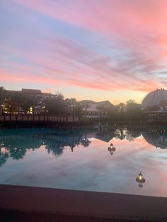 the sun is setting over an empty swimming pool