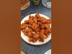 a plate full of fried chicken on a table