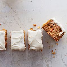 two pieces of cake sitting next to each other on a white counter top with icing