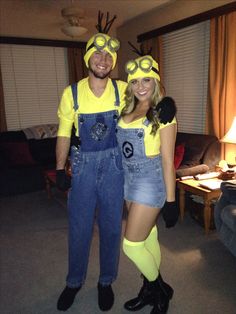 a man and woman dressed in minion costumes posing for a photo together at home