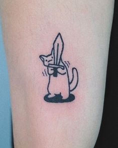 a small cat tattoo on the leg