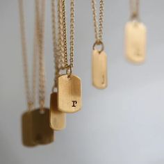 Keep your loved ones close at heart with our tiny yet impactful Initial Mini Tag Necklace. This necklace was designed to be a feminine take on the dog tag necklace. Select your initial and add up to 6 pendants to represent your loved ones. Each letter is individually stamped by hand right justified in the bottom corner of the pendant, making each tag one of a kind. Unique Mothers Day Gifts, Perfect Ring, Signature Style, Dog Tag Necklace, Personalized Jewelry, Mother’s Day, Special Gifts, Mother's Day Gifts, Tags