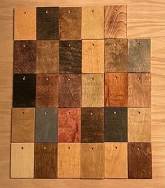 several different colors of wood are arranged on a table with holes in the top half