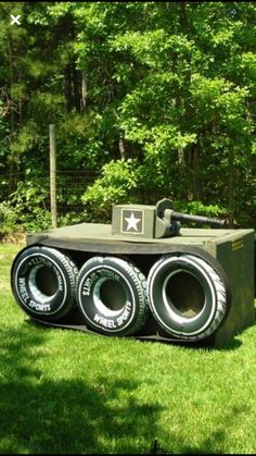 an army tank made out of tires in the grass