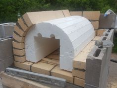 an outdoor pizza oven built into the side of a building with bricks and cements