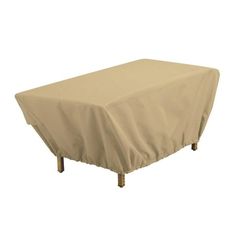 an outdoor table covered with a beige cover on it's legs and wooden legs